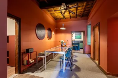 a dining room with orange walls and a table at ROMAC Baullari III - Family apartment in Campo de Fiori in Rome