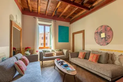 a living room with a couch and a table at ROMAC Baullari III - Family apartment in Campo de Fiori in Rome