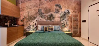 a bedroom with a mural of a man on the wall at Il Magnifico Superior Rooms 400m from Tiburtina Railway Station and 290m from Metro in Rome