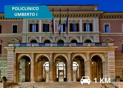 a building with a car parked in front of it at Il Magnifico Superior Rooms 400m from Tiburtina Railway Station and 290m from Metro in Rome