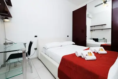 a hotel room with a bed and a glass table at Appartamento vista Colosseo in Rome