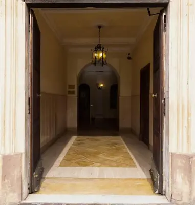 an empty hallway of a building with a chandelier at Appartamento vista Colosseo in Rome