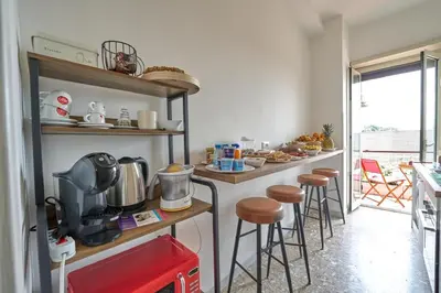 a kitchen with a counter with stools in a room at B&B ErinaHouse in Rome