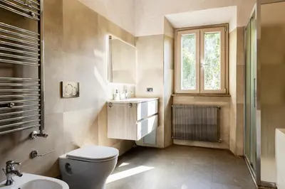 a bathroom with a toilet and a sink and a window at Caffarella Suite in Rome