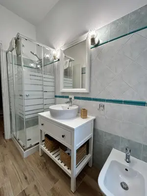 a bathroom with a sink and a glass shower at Appia Little Charme 44 in Rome