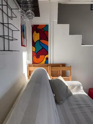 a bedroom with a bed and a painting on the wall at The Artful Flat in Rome