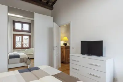 a bedroom with a bed and a television on a dresser at HC - Palazzo Altieri Exclusive Penthouses in Rome