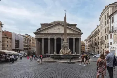a large building with a fountain in the middle of a street at HC - Live Roma Pantheon View in Rome