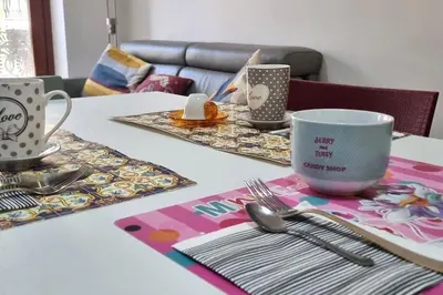 a table with plates and utensils on a table at Caffarella Garden and Park Apartment in Rome