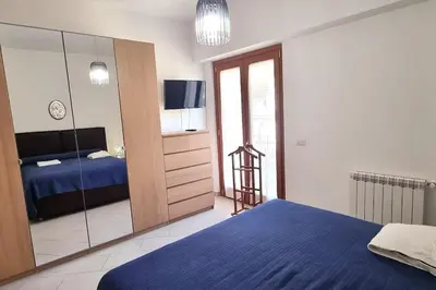 a bedroom with a blue bed and a mirror at Caffarella Garden and Park Apartment in Rome