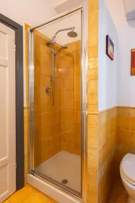 a shower stall in a bathroom with a toilet at Maison Doria Vaticano in Rome
