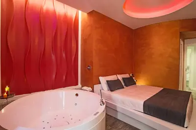 a bathroom with a tub and a bed and a tub at Ripetta Relais in Rome