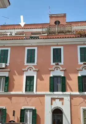 a building with green shutters on it at Blue Sky in Rome