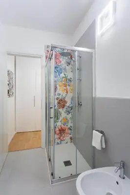 a glass shower in a bathroom with a sink at Vatican 44 in Rome
