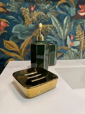 a black and gold perfume bottle sitting on a table at Hestya Domus in Rome