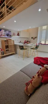 a living room with a kitchen and a living room with a television at Hestya Domus in Rome