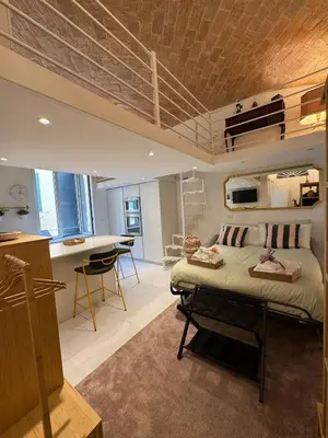 a bedroom with a bed and a kitchen in a room at Hestya Domus in Rome