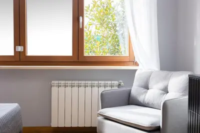 a living room with a chair and a radiator at Dona's House in Rome