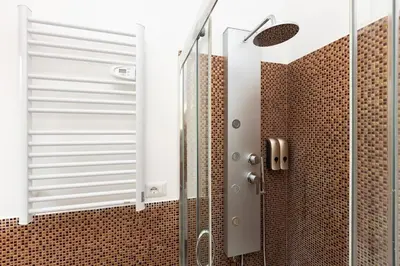 a shower with a glass door in a bathroom at Dona's House in Rome