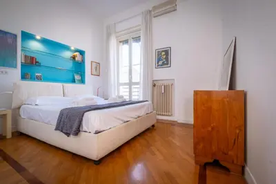 a bedroom with a bed with a blue headboard at Vatican Museum apartment by Varental in Rome
