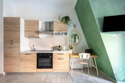a kitchen with wooden cabinets and a table with chairs at Vaticano 44 by Hili in Rome