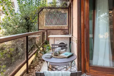 a small table on a balcony with a stove at Vaticano 44 by Hili in Rome