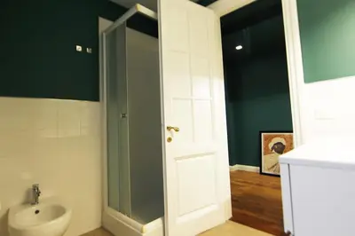 a bathroom with a sink and a toilet and a door at Casa di Paolo a Fontana di Trevi in Rome