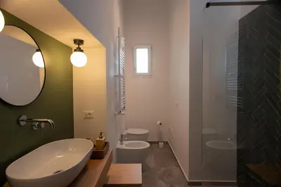a bathroom with a tub and a sink and a mirror at Colosseo Apartment 183 in Rome