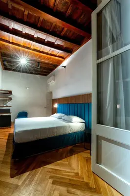 a bedroom with a bed and a wooden ceiling at AGH - Capranica in Rome