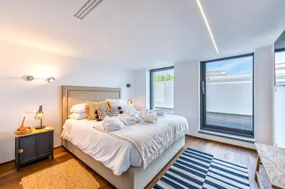 a bedroom with a bed and a large window at Skylife Tiber Luxury Penthouse in Rome