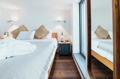 a bedroom with two beds and a mirror at Skylife Tiber Luxury Penthouse in Rome