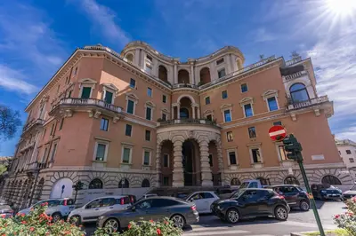 a large building with cars parked in front of it at Casa Belle Arti in Rome