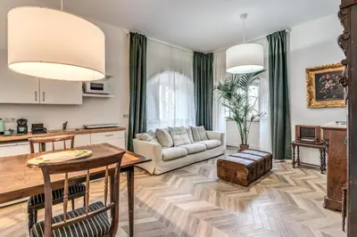 a living room with a table and a couch at Casa Belle Arti in Rome