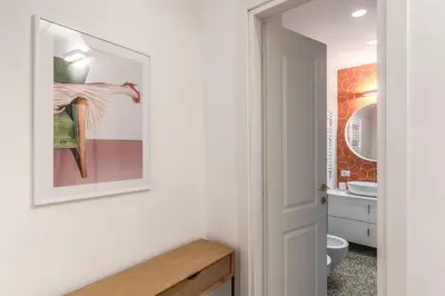 a bathroom with a toilet and a mirror at Silent 2 Bdrm heart of Trastevere in Rome