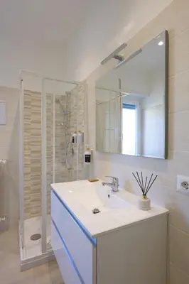 a bathroom with a sink and a mirror and a shower at Luxury Suite-Metro Malatesta in Rome