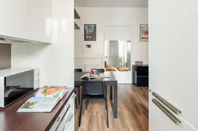 a kitchen with a table and a dining room at San Giovanni Living House in Rome
