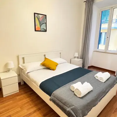 a bedroom with a bed with two towels on it at Angelico Home in Rome
