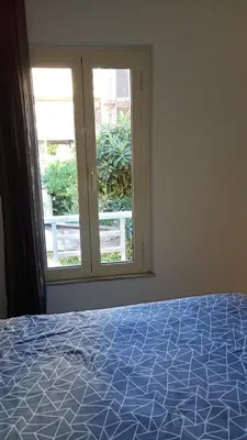 a bedroom with a bed and a window at Ponte Milvio Loft in Rome