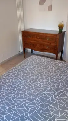 a bedroom with a bed and a dresser in a room at Ponte Milvio Loft in Rome