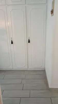 two white doors in a room with a tile floor at Ponte Milvio Loft in Rome