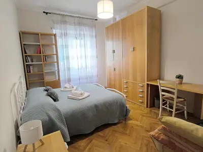 a bedroom with a bed and a desk and a table at Alloggio Turistico Giotta in Rome
