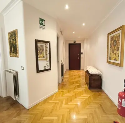 a hallway with a wooden floor in a building at Alloggio Turistico Giotta in Rome