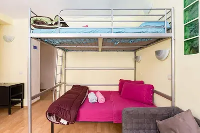 a bedroom with a bunk bed and a couch at Holiday Home Naiadis in Rome