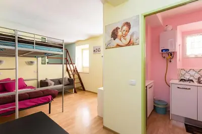 a room with a bunk bed and a living room at Holiday Home Naiadis in Rome
