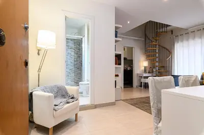 a kitchen and living room with a table and chairs at Casa Tiburtina in Rome