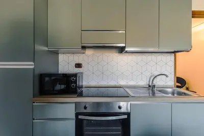 a kitchen with a sink and a microwave at Maison Riboty in Rome