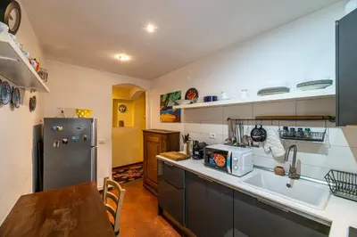 a kitchen with a sink and a refrigerator at Rooma Duplex Campo de Fiori in Rome