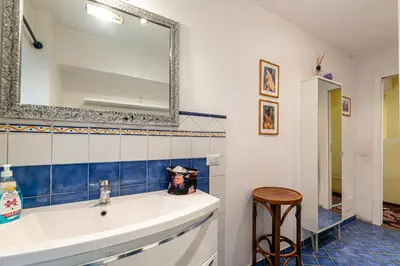 a bathroom with a sink and a mirror at Rooma Duplex Campo de Fiori in Rome