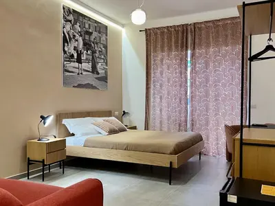 a bedroom with a bed and a pink curtain at Alma Domus Feriae - Roma in Rome