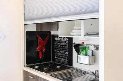a kitchen with a stove top oven in a kitchen at Casa Vacanze Marrucini in Rome